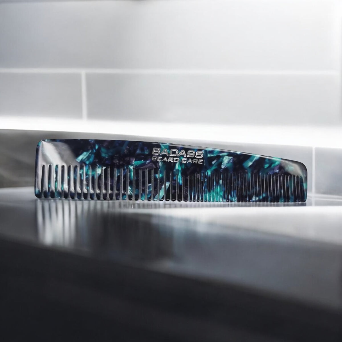 Marbled acetate beard comb standing beside a sink