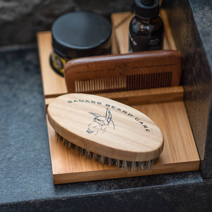 Wooden Beard Brush on a grooming tray with comb, oil and butter